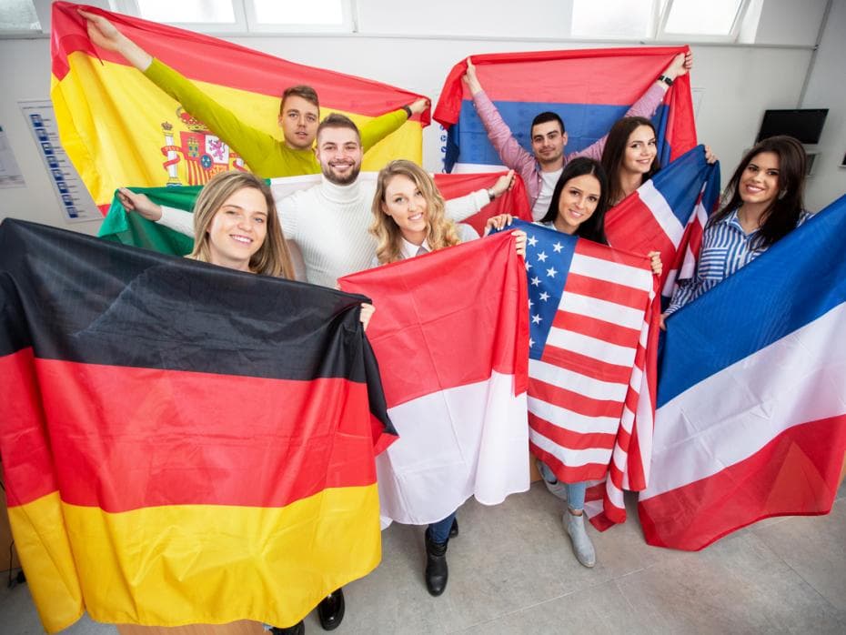 International students holding up flags of their home countries