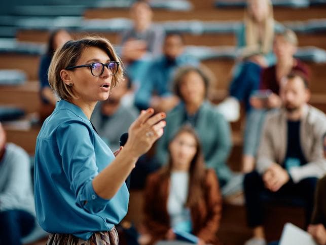 woman speaking in a lecture hall