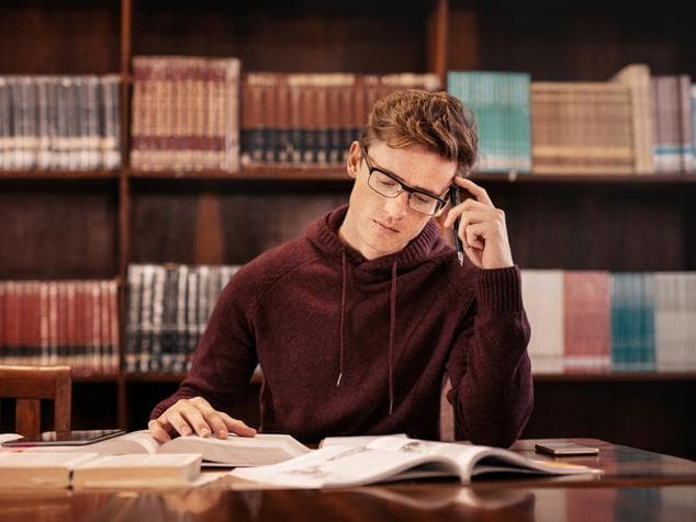 Male university student in library