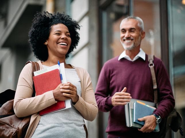 Young woman and older man adult students lifelong learning