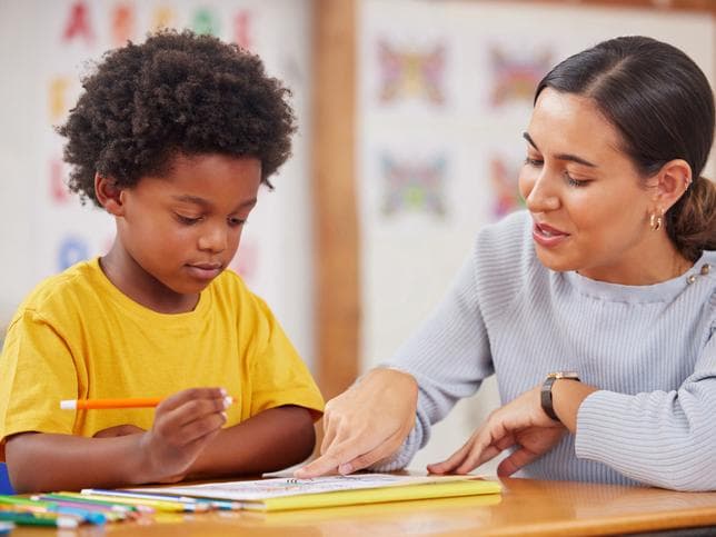 Young teacher working with child