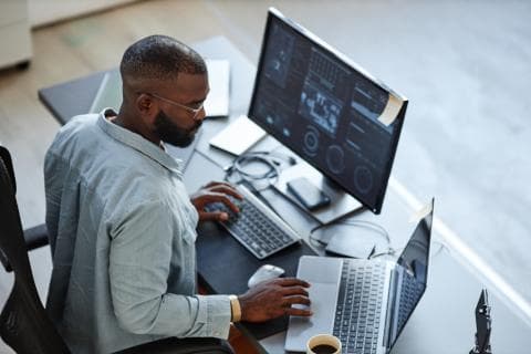 A young man at a computer analysing data