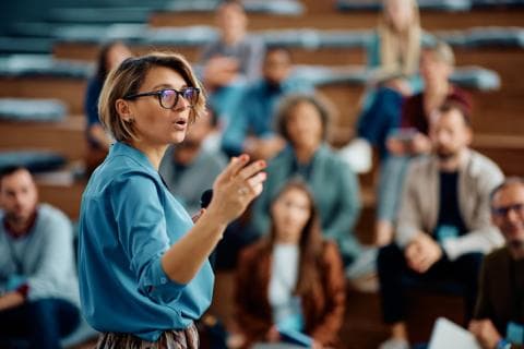 woman speaking in a lecture hall