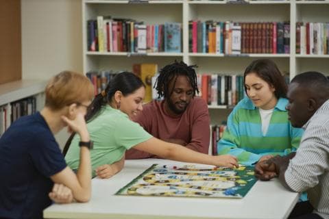 Students playing a board game