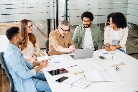 A group of people work around an office table