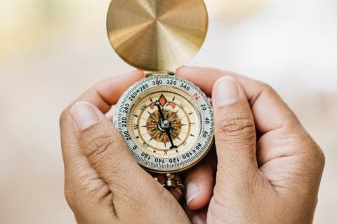 Hands holding a compass