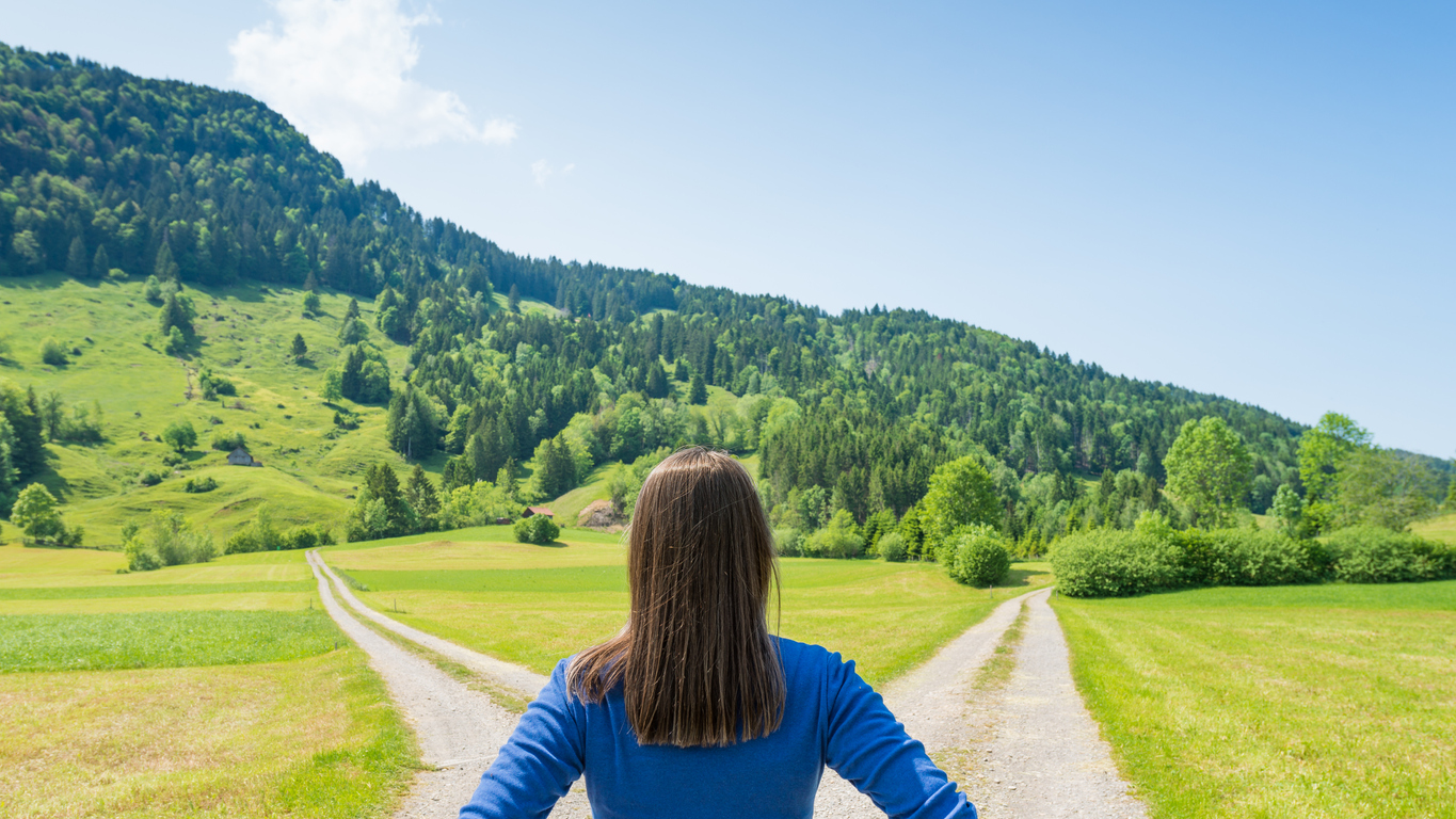 Woman standing at crossroads