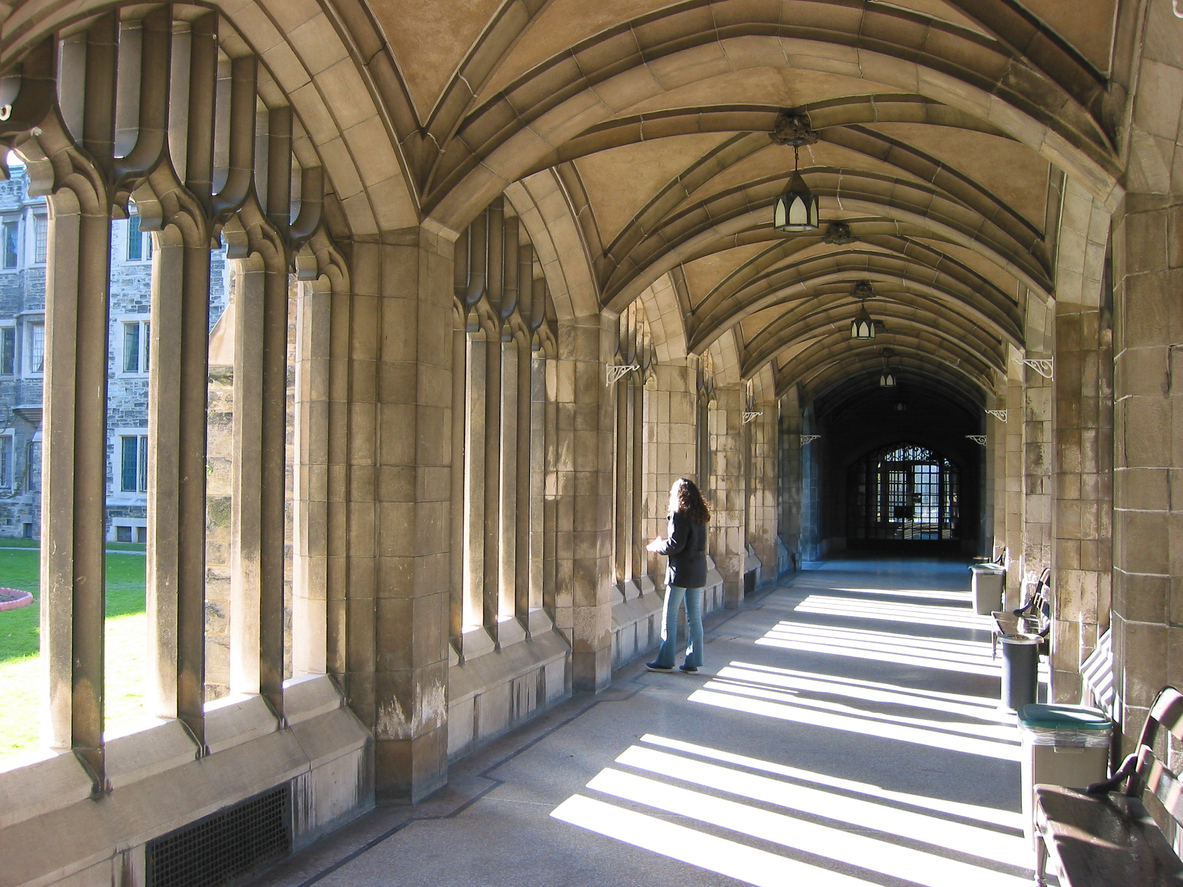 Student standing in Oxbridge college cloister