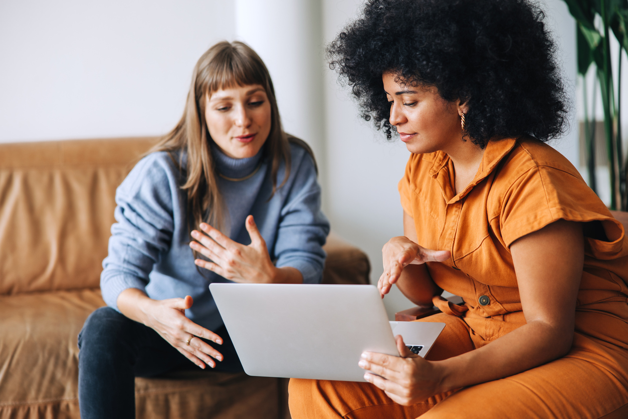 Counsellor and parent looking at a laptop together