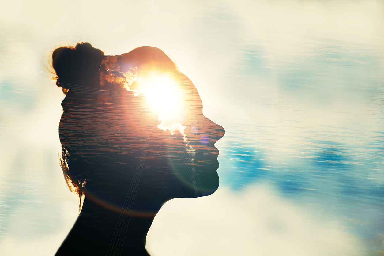 Woman with sunlight appearing to shine through her head