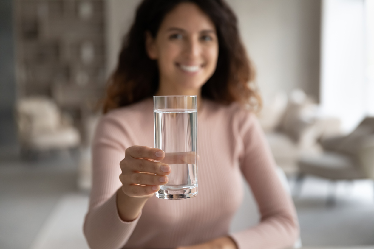 Woman holding glass of water