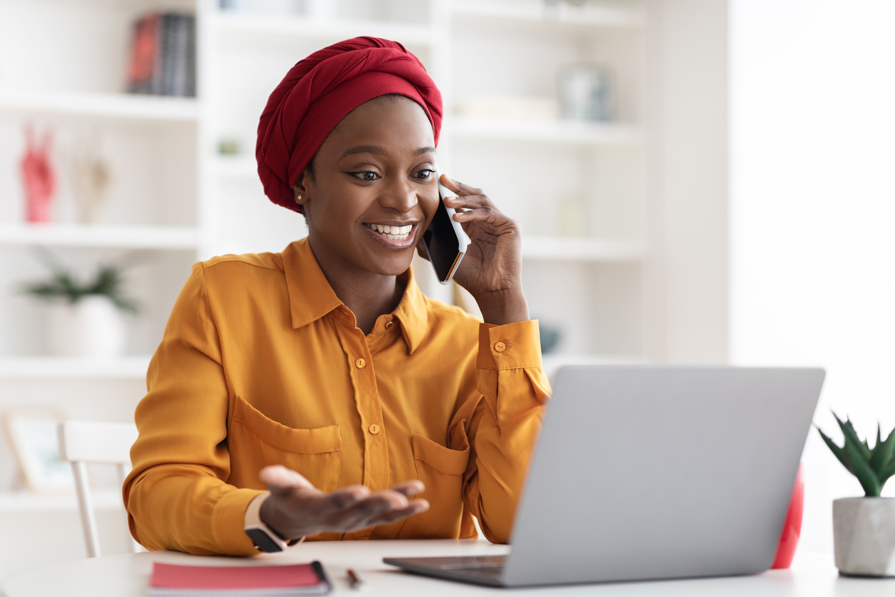 Woman in office, talking on phone