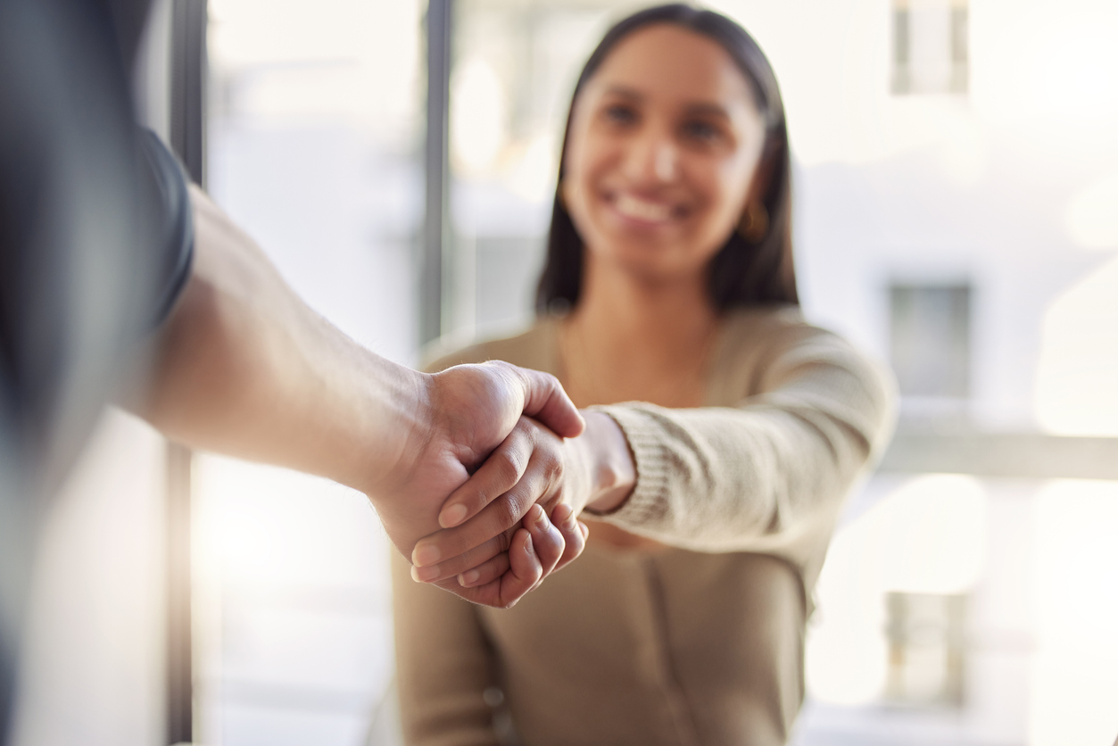 A woman and a man shaking hands