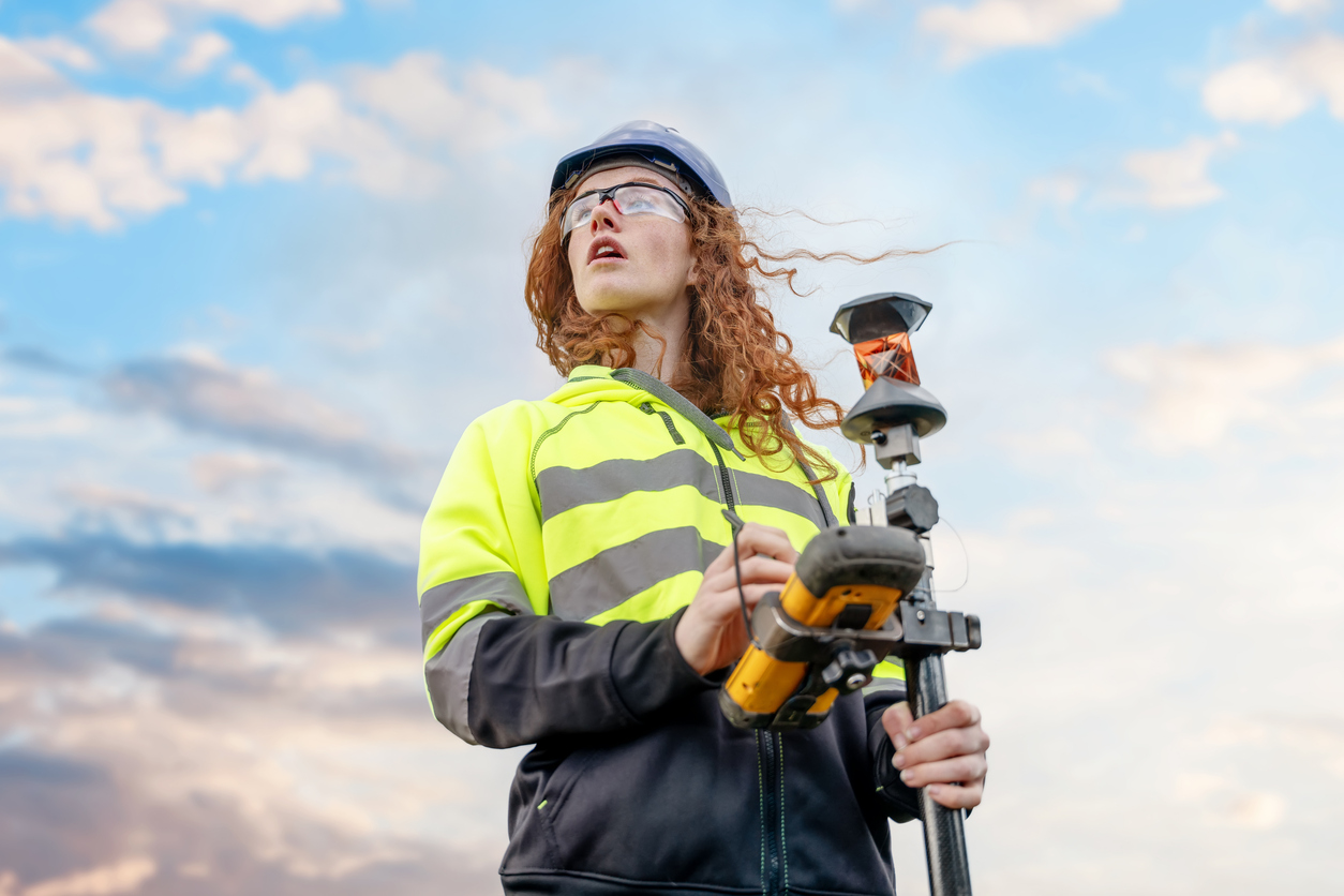 Apprentice surveyor, looking out over land