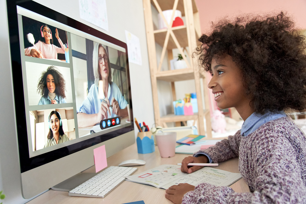 Girl looking at computer screen, learning virtually