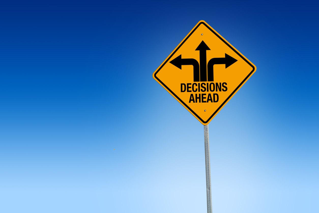 Road sign showing three arrows above the words 'Decisions ahead'