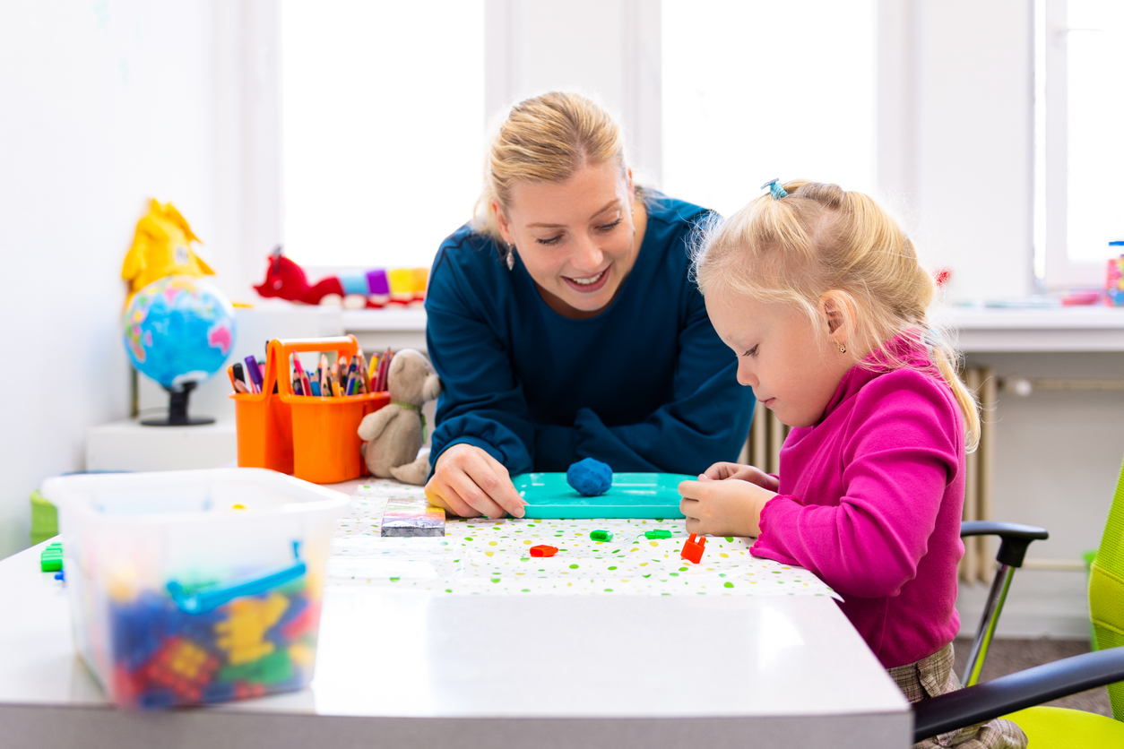 Occupational therapist working with young child