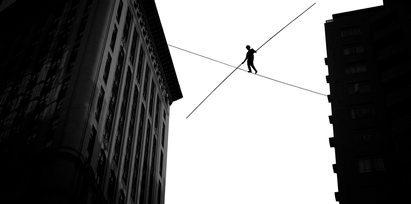 man walking on tightrope