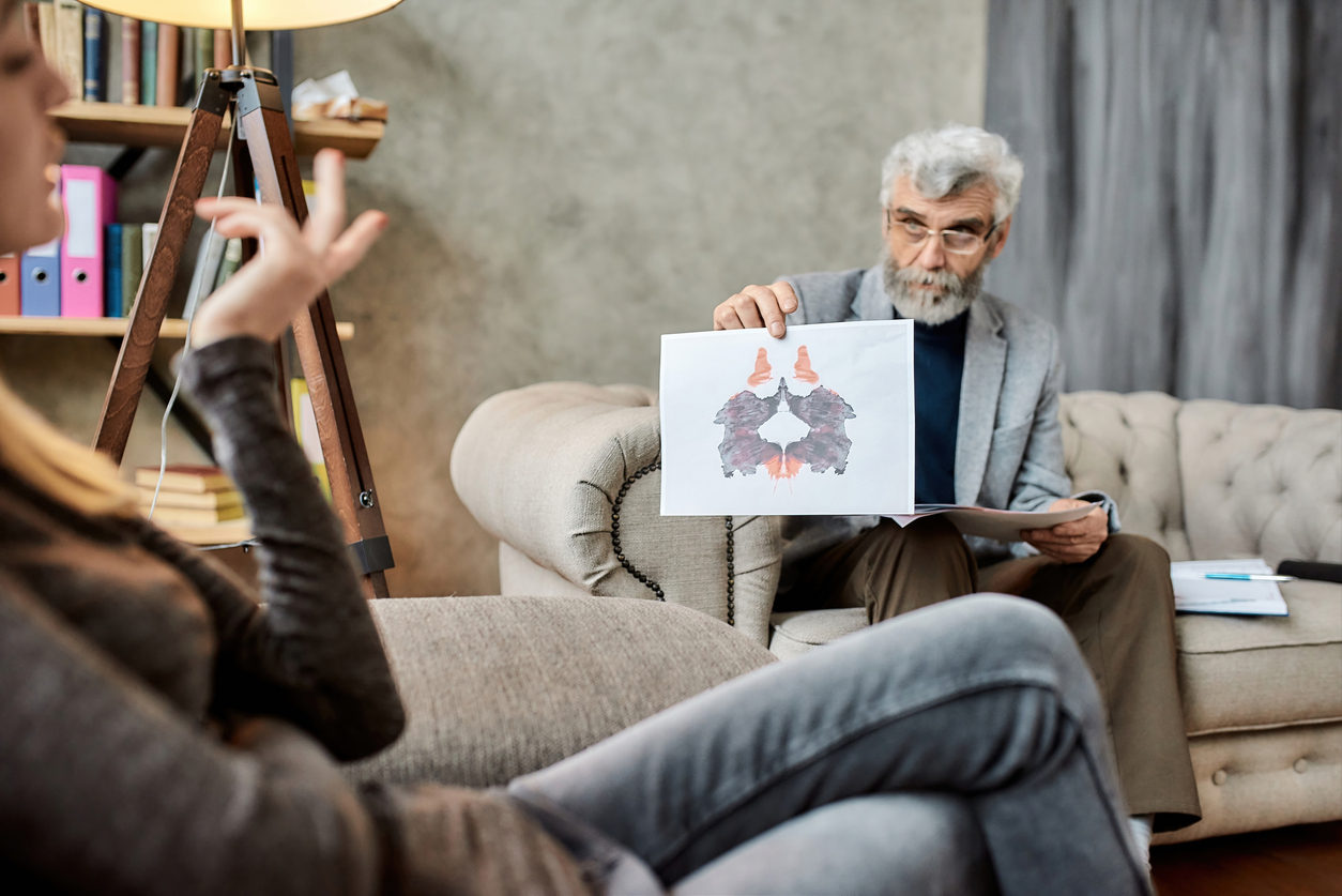 Psychotherapist showing client a Rorschach inkblot