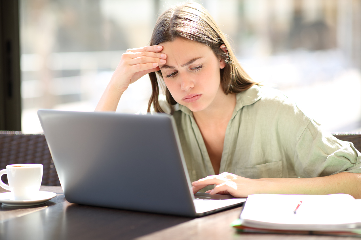 Frustrated student working at laptop