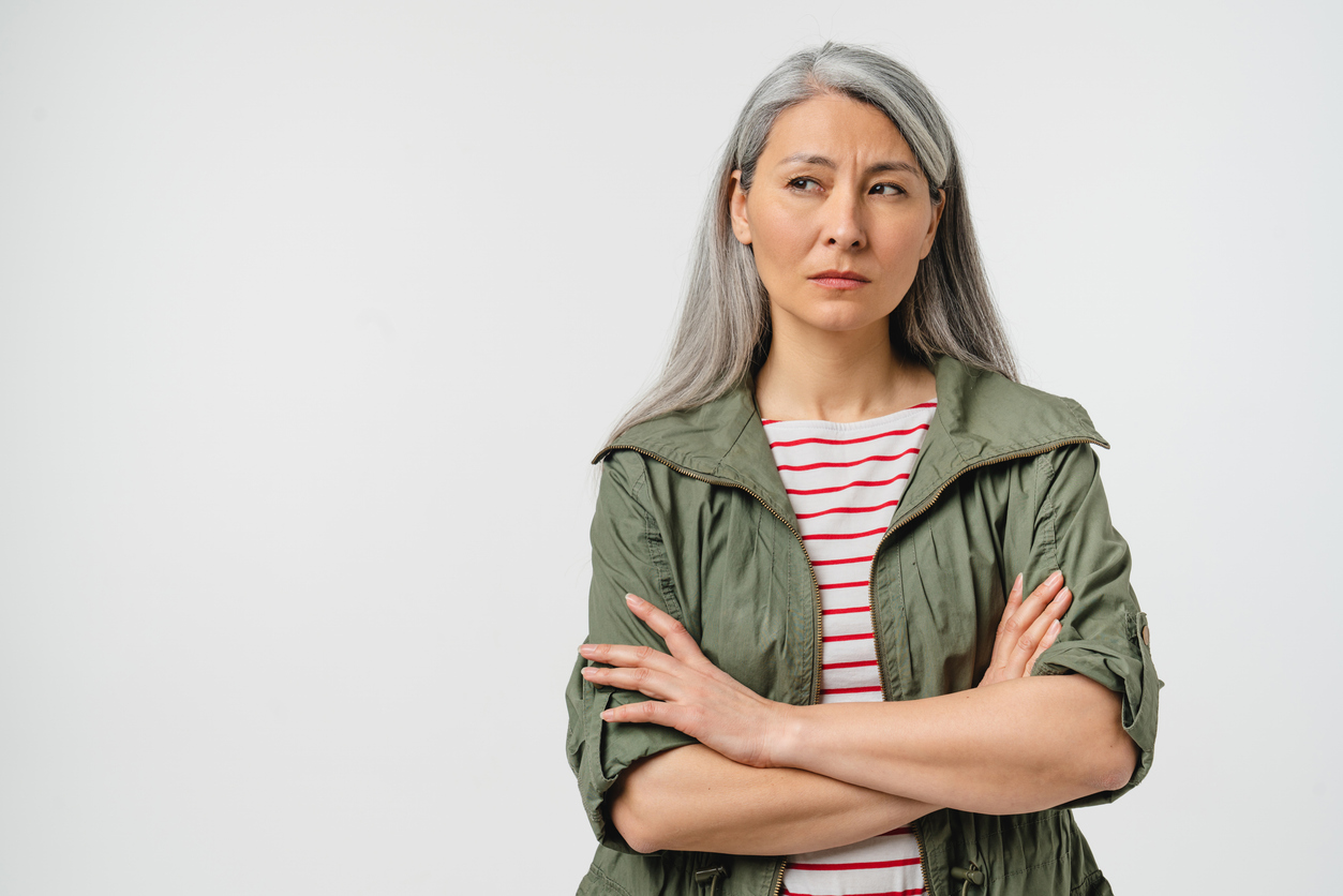 Woman with arms folded, looking sceptical