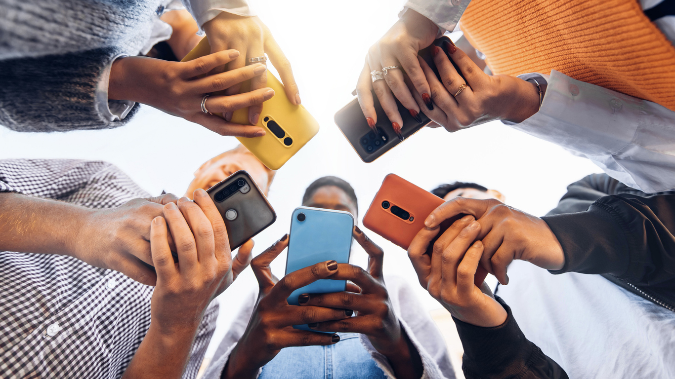 Students in a circle, all using their phones