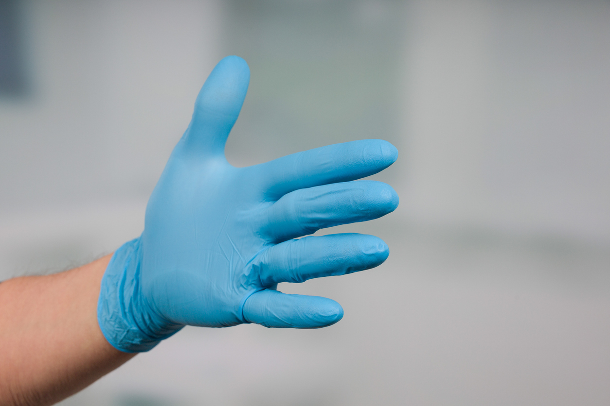 Extended hand, in surgical glove