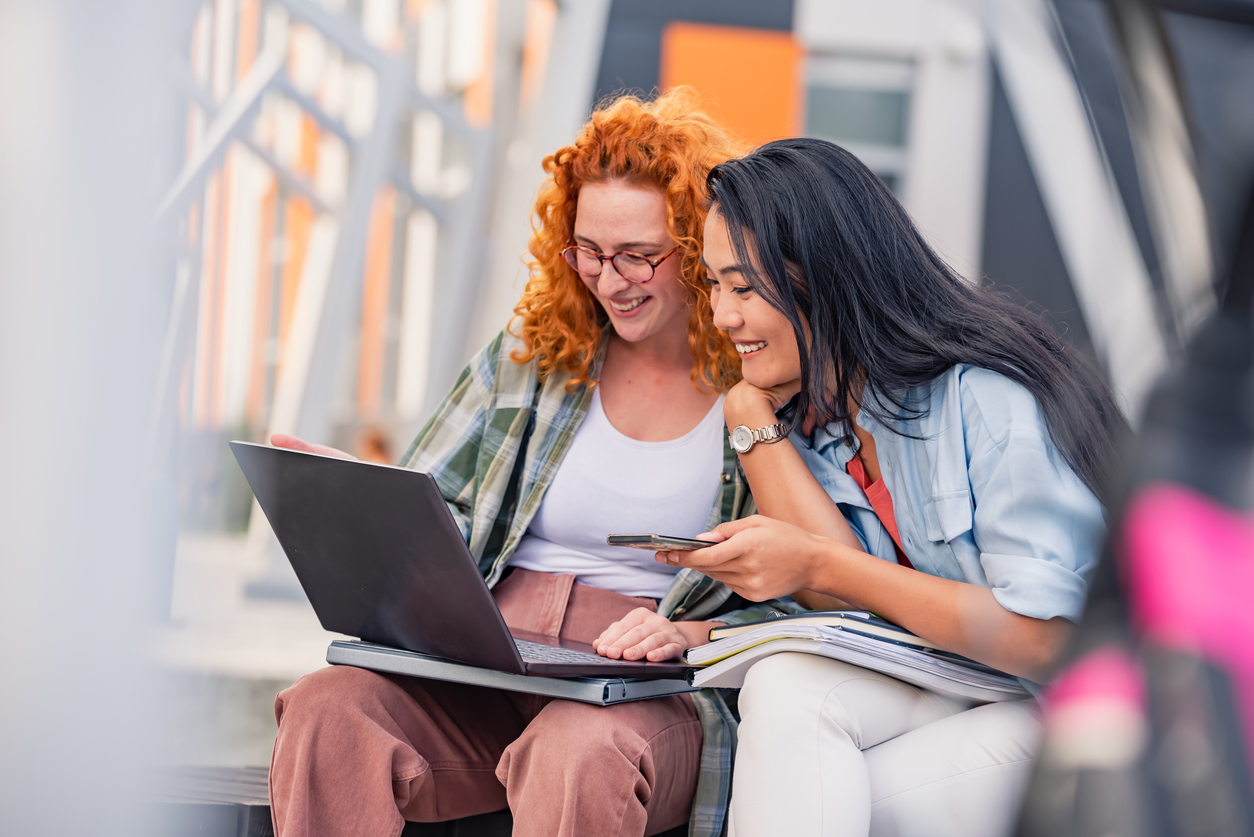 Two Canadian students, looking at a laptop