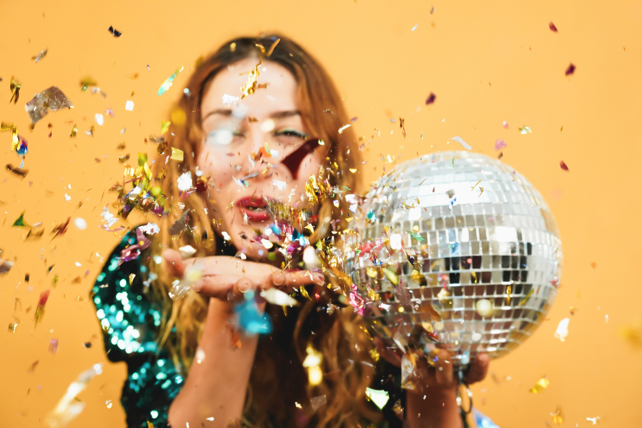 Woman with disco ball and confetti