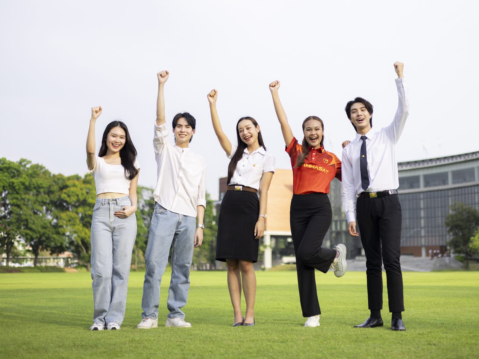 Students raising their hands in celebration