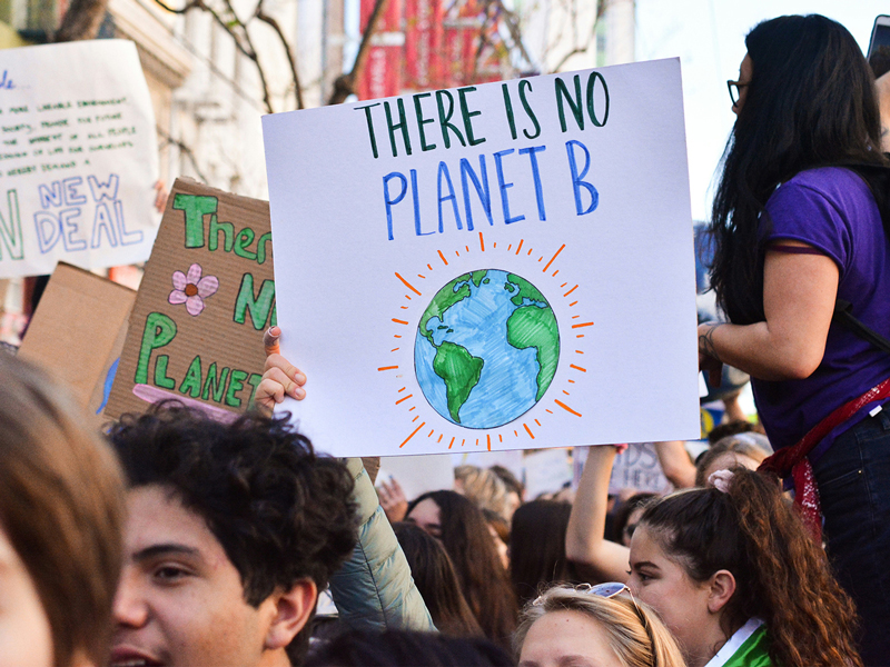 Climate protestors holding a sign that says "there is no planet B"