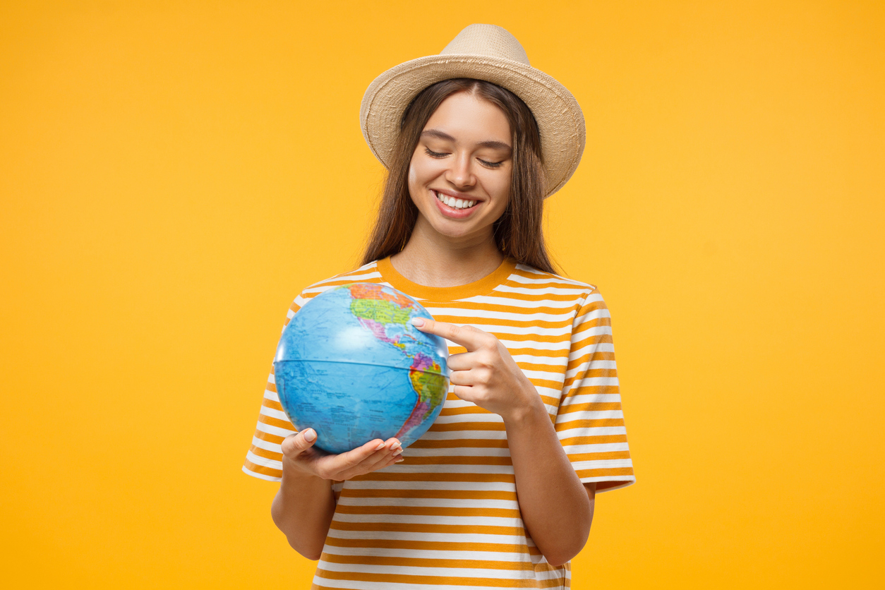 Student pointing at place on globe