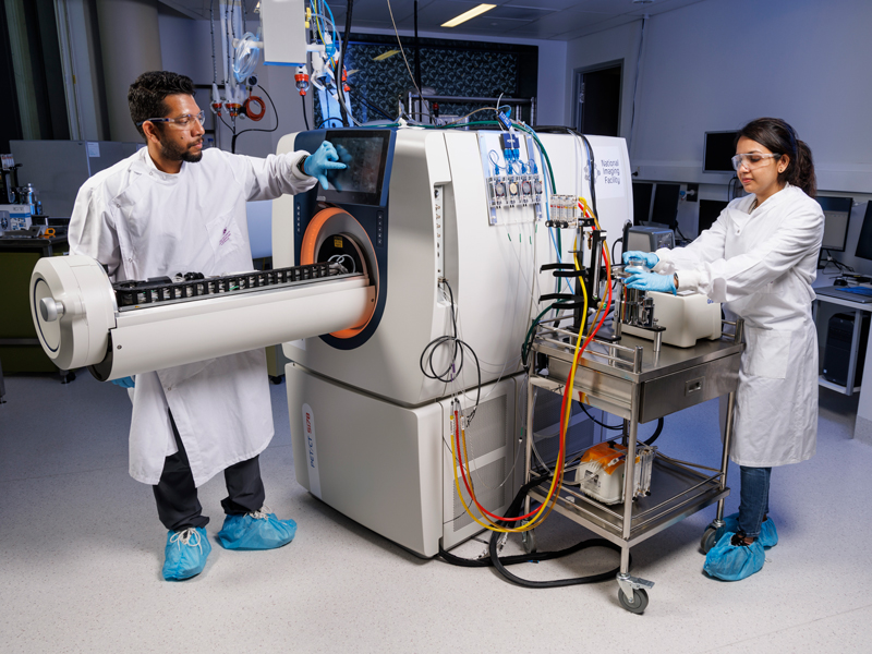 Two University of Queensland radiopharmaceutical researchers in a laboratory