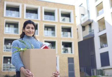 Student carrying box arrives at university