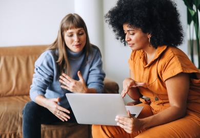 Counsellor and parent looking at a laptop together