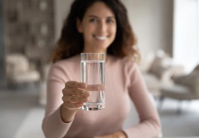 Woman holding glass of water