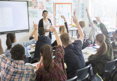 Teacher in a classroom with teenage students