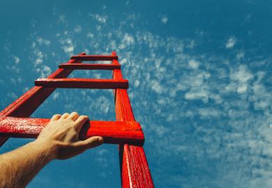 Hand on rung of ladder reaching up to the sky