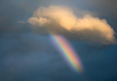 Rainbow peeking through storm clouds