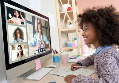 Girl looking at computer screen, learning virtually