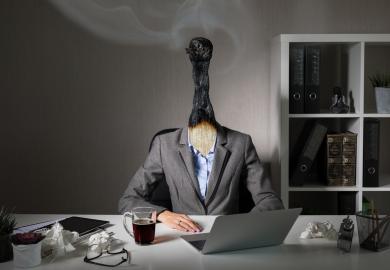 Woman sitting at her desk, with her head replaced by a burnt-out match