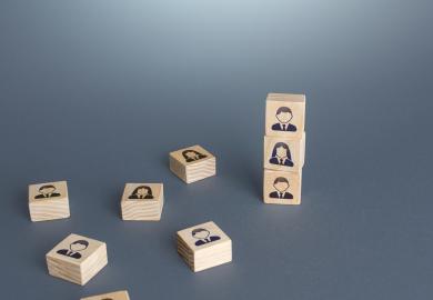 Blocks with students' faces on them, either piled up or laid flat