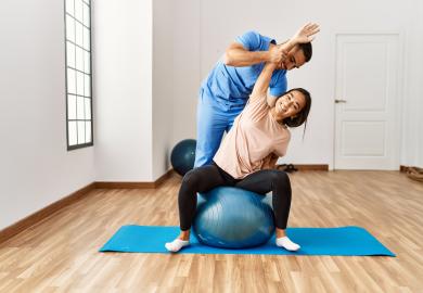 Physiotherapist, stretching woman's arm