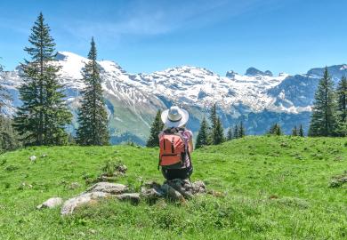 Student looking out at the Swiss Alps