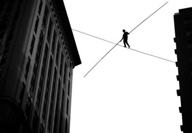 man walking on tightrope