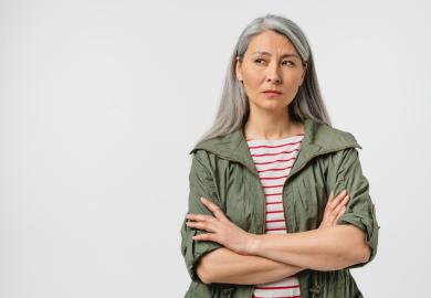 Woman with arms folded, looking sceptical