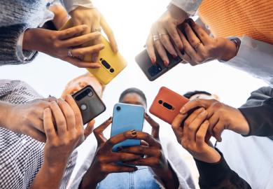 Students in a circle, all using their phones