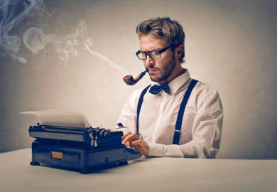 Author smoking pipe and sitting at typewriter