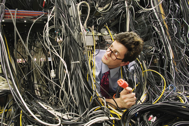 male-it-worker-buried-in-computer-cables.jpg