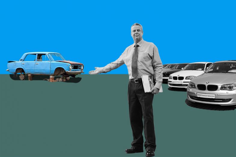 Car salesman pointing away from new cars to an old broken car, illustrating the less generous pension offered to university staff if employed through a subsidiary company.